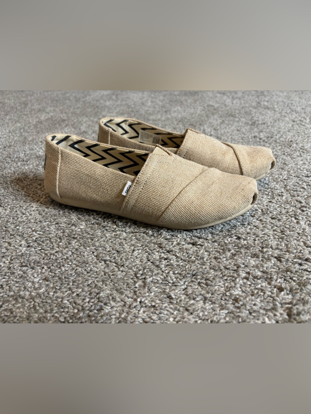Woman’s Toms shoes.